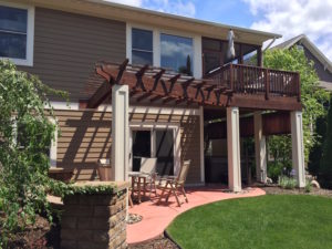A nice backyard patio with a pergola. The hot tub resides under the porch.