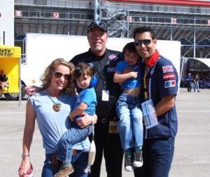 Four wonderful and attractive people and some guy from a racing team.